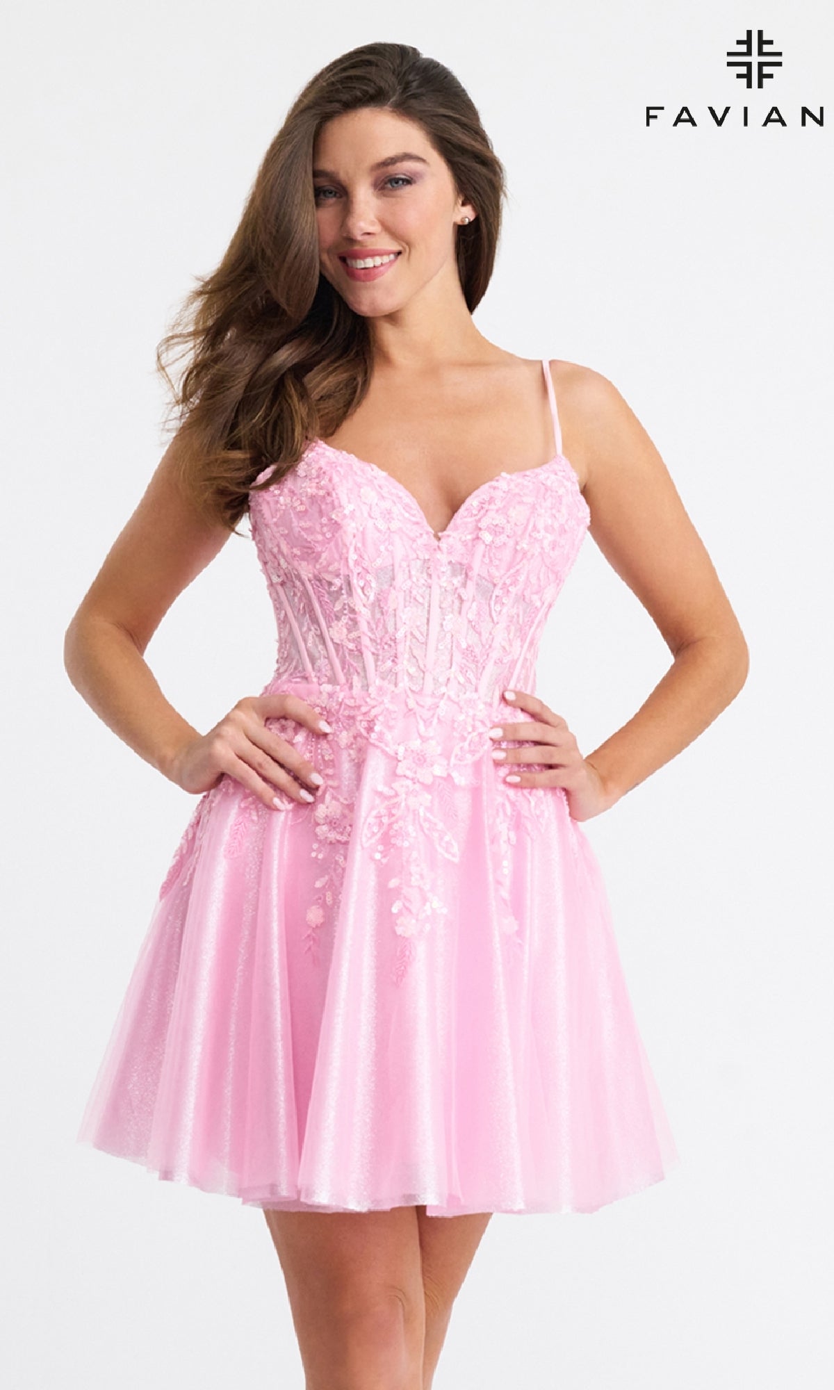 A woman wears the Faviana 11305 short fit-and-flare hoco dress in light pink, featuring beaded floral appliqué and a fitted bodice. The Faviana logo is shown in the top right corner.